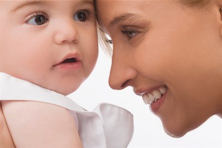 Close-up of a mid adult woman smiling with her son Stock Photo - Premium Royalty-Free, Code: 625-02267320