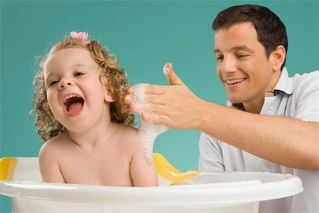 daddy daughter bath - Close-up of a mid adult man giving bath to his daughter Stock Photo - Premium Royalty-Free, Code: 625-02267322