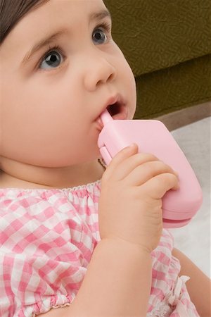 Close-up of a girl holding a toy phone Stock Photo - Premium Royalty-Free, Code: 625-02267487