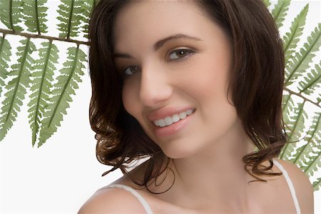 simsearch:625-02267557,k - Close-up of a young woman with fern Stock Photo - Premium Royalty-Free, Code: 625-02267528