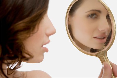 simsearch:625-02267557,k - Close-up of a young woman looking at a mirror Stock Photo - Premium Royalty-Free, Code: 625-02267540