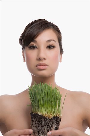 simsearch:625-02267557,k - Portrait of a young woman holding wheatgrass Stock Photo - Premium Royalty-Free, Code: 625-02267597