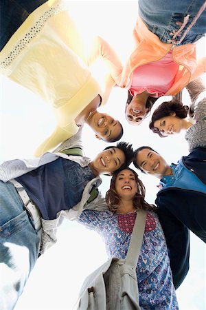 Low angle view of a group of friends smiling Stock Photo - Premium Royalty-Free, Code: 625-02267686