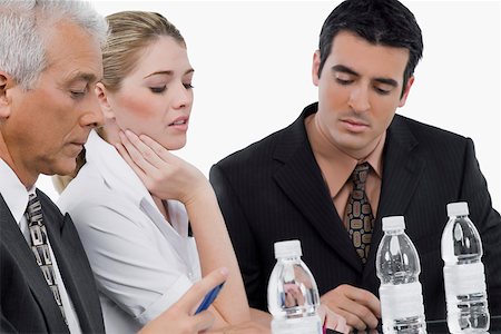 scheme - Two businessmen and a businesswoman at a meeting in a conference room Stock Photo - Premium Royalty-Free, Code: 625-02267805