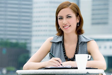 Portrait of a businesswoman at a sidewalk cafe Stock Photo - Premium Royalty-Free, Code: 625-02267815