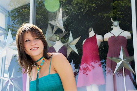 simsearch:625-02266783,k - Close-up of a young woman window shopping and smiling Stock Photo - Premium Royalty-Free, Code: 625-02267830