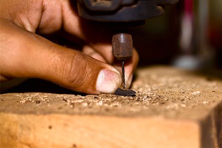 Close-up of a person's finger drilling, Izamal, Yucatan, Mexico Stock Photo - Premium Royalty-Free, Code: 625-02267937