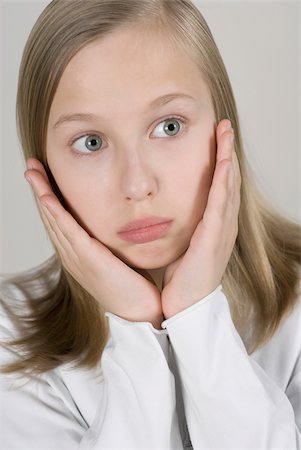 shocked tween girls - Close-up of a girl with her head in her hands Stock Photo - Premium Royalty-Free, Code: 625-02926699