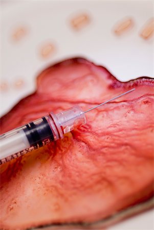 Close-up of a syringe on blood cell Stock Photo - Premium Royalty-Free, Code: 625-02926789