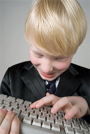 Close-up of a boy holding a computer keyboard Stock Photo - Premium Royalty-Free, Code: 625-02926814