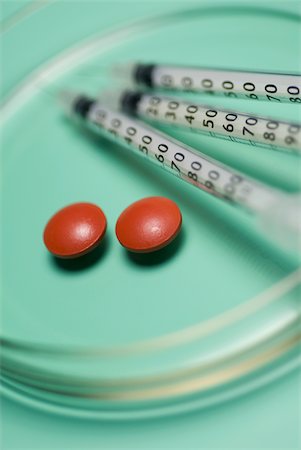 Close-up of three syringes with pills in a petri dish Foto de stock - Sin royalties Premium, Código: 625-02926972