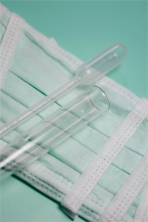 Close-up of a test tube and a pipette on a surgical mask Stock Photo - Premium Royalty-Free, Code: 625-02927196