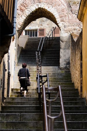 Rear view of a woman moving up on staircase, Escalier de la Grande Poterne, Le Mans, Sarthe, France Foto de stock - Sin royalties Premium, Código: 625-02927727