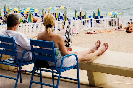 french riviera - Rear view of a couple sitting in armchairs on the beach, Plage De La Croisette, Cote d'Azur, Cannes, Provence-Alpes-Cote D'Azur, France Stock Photo - Premium Royalty-Free, Code: 625-02927789