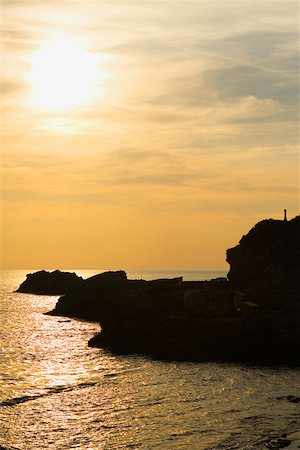 Silhouette of rocks in the ocean, Baie de Biarritz, Biarritz, France Stock Photo - Premium Royalty-Free, Code: 625-02928246