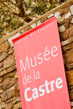 Close-up of a banner hanging on a stone wall, Musee De La Castre, Cote d'Azur, Cannes, Provence-Alpes-Cote D'Azur, France Fotografie stock - Premium Royalty-Free, Codice: 625-02928443