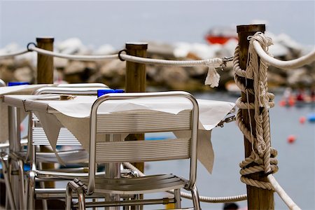 Chairs and table at a sidewalk cafe, Italian Riviera, Cinque Terre National Park, Il Porticciolo, Vernazza, La Spezia, Liguria, Italy Foto de stock - Sin royalties Premium, Código: 625-02928659