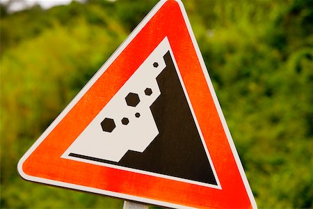road signs safety - Close-up of a landslide road sign, Via Aurelia, Italian Riviera, Liguria, Italy Stock Photo - Premium Royalty-Free, Code: 625-02928676