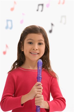 fossetta - Portrait of a schoolgirl holding a flute and smiling Fotografie stock - Premium Royalty-Free, Codice: 625-02928954