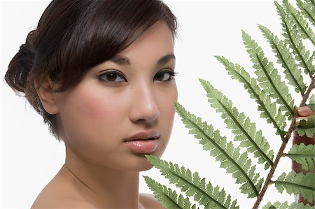 simsearch:625-02267557,k - Portrait of a young woman holding a fern Stock Photo - Premium Royalty-Free, Code: 625-02929003