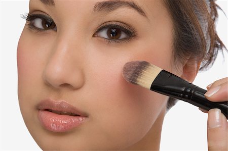 simsearch:625-02267557,k - Portrait of a young woman applying make-up Stock Photo - Premium Royalty-Free, Code: 625-02929014