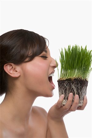 simsearch:625-02267557,k - Close-up of a young woman eating wheatgrass Stock Photo - Premium Royalty-Free, Code: 625-02929012