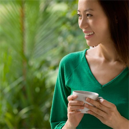 simsearch:625-02929093,k - Close-up of a young woman holding a cup of tea and smiling Stock Photo - Premium Royalty-Free, Code: 625-02929067