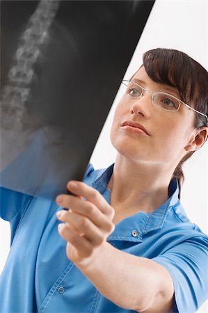 doctor looking at xray - Female surgeon examining an X-Ray Stock Photo - Premium Royalty-Free, Code: 625-02929186