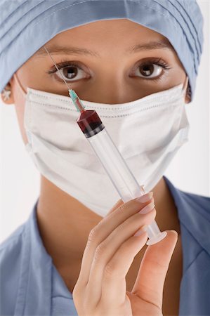 doctor syringe close up - Portrait of a female surgeon holding a syringe Stock Photo - Premium Royalty-Free, Code: 625-02929189