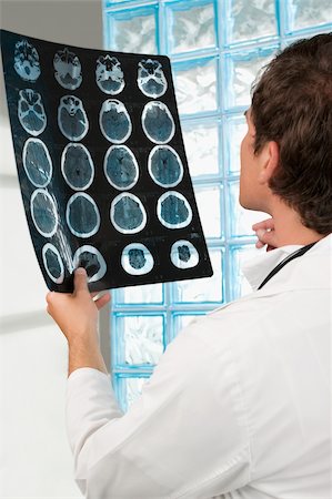 Male doctor examining an X-Ray report Stock Photo - Premium Royalty-Free, Code: 625-02929206