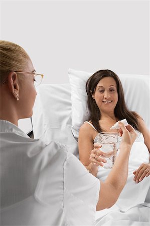 patient satisfaction - Female doctor giving medicine to a mature woman Stock Photo - Premium Royalty-Free, Code: 625-02929247