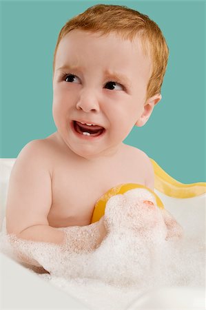 Close-up of a boy sitting in a bathtub and crying Stock Photo - Premium Royalty-Free, Code: 625-02929314