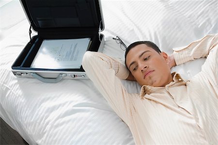 Businessman lying on the bed Stock Photo - Premium Royalty-Free, Code: 625-02929349