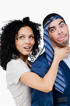 female strangle male - Businesswoman pretending to strangulate a businessman Stock Photo - Premium Royalty-Free, Code: 625-02929421