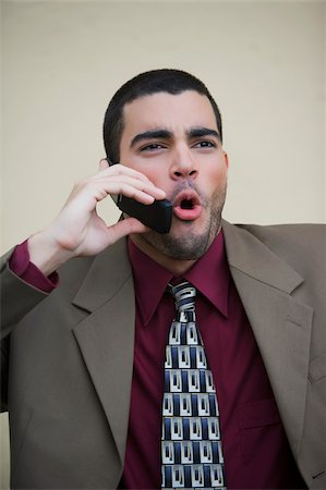 Close-up of a businessman talking on a mobile phone Stock Photo - Premium Royalty-Free, Code: 625-02929438