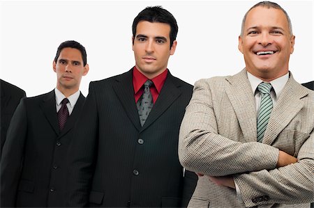 simsearch:625-02930851,k - Portrait of a businessman smiling and three businessmen standing behind him Stock Photo - Premium Royalty-Free, Code: 625-02929530