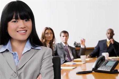 Portrait of a businesswoman with her colleagues in the background Stock Photo - Premium Royalty-Free, Code: 625-02929570
