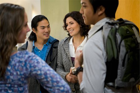 students chatting - University students talking in a corridor Stock Photo - Premium Royalty-Free, Code: 625-02929682