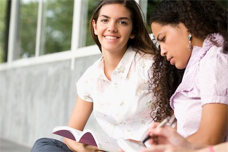 excited college student with books - Two university students studying in a corridor Stock Photo - Premium Royalty-Free, Code: 625-02929698