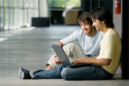 Two young men working on a laptop Stock Photo - Premium Royalty-Free, Code: 625-02929699