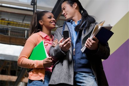 simsearch:625-02929730,k - Low angle view of a young couple holding their textbooks Foto de stock - Sin royalties Premium, Código: 625-02929703