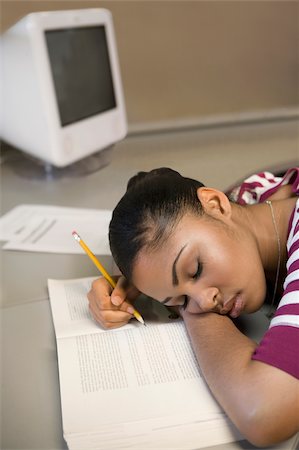 sleeping in a classroom - Young man napping on a book Stock Photo - Premium Royalty-Free, Code: 625-02929734