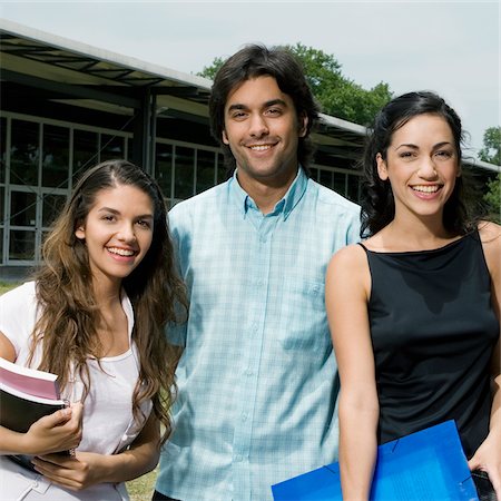 excited college student with books - Portrait of three university students standing together and smiling Stock Photo - Premium Royalty-Free, Code: 625-02929767