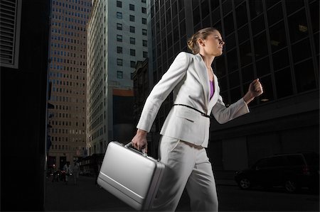 road into city low angle - Low angle view of a businesswoman carrying a briefcase Stock Photo - Premium Royalty-Free, Code: 625-02929884