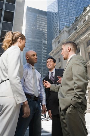 simsearch:625-02929907,k - Side profile of a businesswoman standing with three businessmen Stock Photo - Premium Royalty-Free, Code: 625-02929888