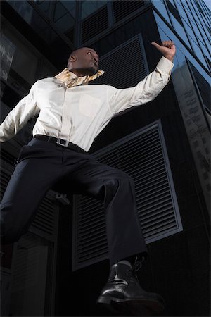 Low angle view of a businessman jumping with a briefcase Stock Photo - Premium Royalty-Free, Code: 625-02930001