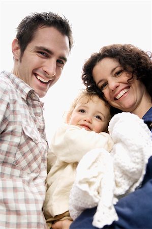 simsearch:625-02266718,k - Portrait of a couple smiling with their daughter Fotografie stock - Premium Royalty-Free, Codice: 625-02930098