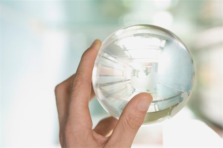 people holding globe - Close-up of a person's hand holding a globe Stock Photo - Premium Royalty-Free, Code: 625-02930158