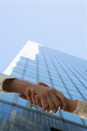 Low angle view of two people shaking hands Stock Photo - Premium Royalty-Free, Code: 625-02930164