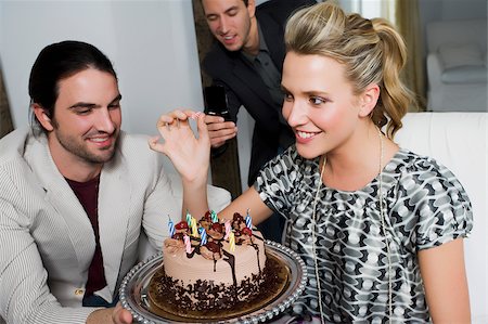 people shocked on phones - Young woman celebrating birthday with her friends Stock Photo - Premium Royalty-Free, Code: 625-02930209